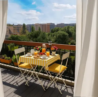 a table and chairs on a balcony with a view at TraStella, Trastevere di charme, balcone & hammam in Rome