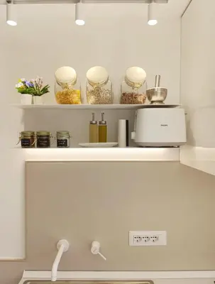 a kitchen with a shelf with jars of food at TraStella, Trastevere di charme, balcone & hammam in Rome
