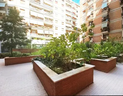 a courtyard in a apartment building with plants at TraStella, Trastevere di charme, balcone & hammam in Rome