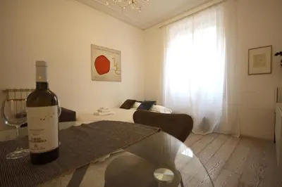 a bottle of wine sitting on a table in a living room at Art & Music Holiday Home in Rome