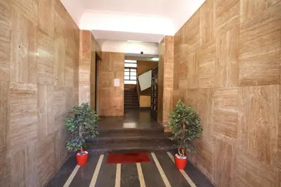 a hallway with wooden walls and two potted plants at Art & Music Holiday Home in Rome