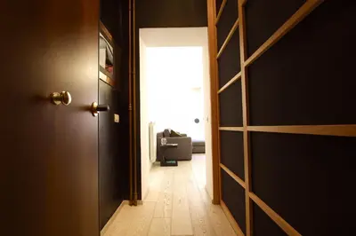 an open door leading to a room with a chair at Art & Music Holiday Home in Rome