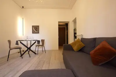 a living room with a couch and a table at Art & Music Holiday Home in Rome