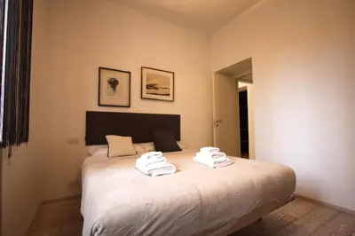 a bedroom with a bed with towels on it at Art & Music Holiday Home in Rome