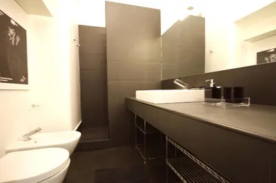 a bathroom with a sink and a toilet and a mirror at Art & Music Holiday Home in Rome