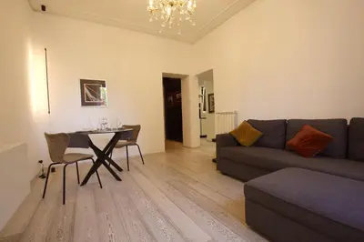 a living room with a couch and a table at Art & Music Holiday Home in Rome