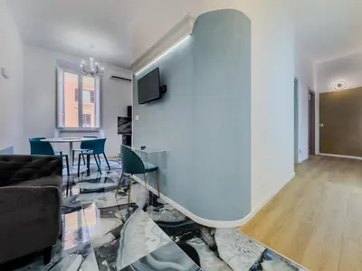a bedroom with a large white bed and a chair at Santamaura Vacanze Vaticane Elegance e Comfort in Rome