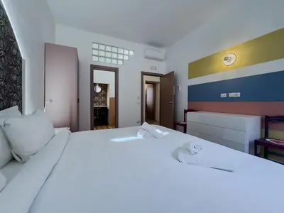 a white bed with white pillows in a bedroom at Santamaura Vacanze Vaticane Elegance e Comfort in Rome