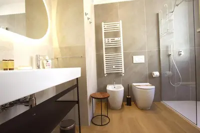 a bathroom with a toilet and a sink and a shower at Claudia 2BR Holiday Home in Rome