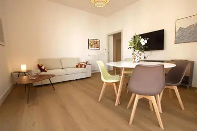 a living room with a table and chairs and a couch at Claudia 2BR Holiday Home in Rome