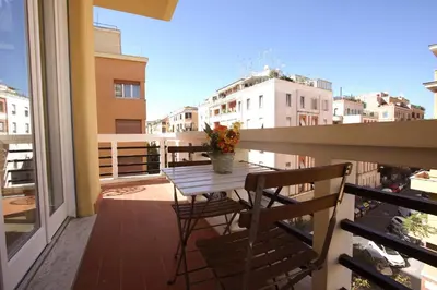 a balcony with a table and chairs on a balcony at Claudia 2BR Holiday Home in Rome