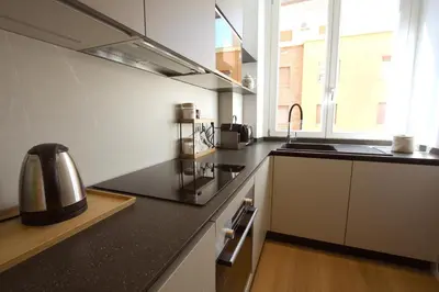 a kitchen with a sink and a stove top oven at Claudia 2BR Holiday Home in Rome