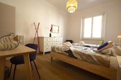 a bedroom with a bed and a desk and a table at Claudia 2BR Holiday Home in Rome