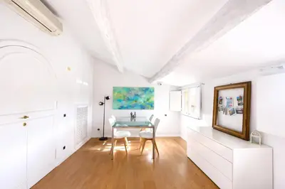 a dining room with a glass table and white chairs at Panoramic Terrace Trastevere Apartment Amazing view in Rome