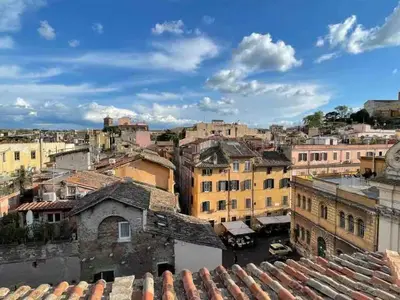 an archway in a kitchen with a table and a dining room at Panoramic Terrace Trastevere Apartment Amazing view in Rome