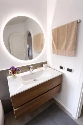a kitchen with a vase of flowers on a table at Panoramic Terrace Trastevere Apartment Amazing view in Rome