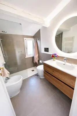 a white bedroom with a bed and a flat screen tv at Panoramic Terrace Trastevere Apartment Amazing view in Rome
