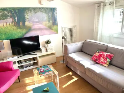 a living room with a couch and a pink chair at Panoramic Terrace Trastevere Apartment Amazing view in Rome