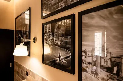 a couple of framed pictures hanging on a wall at Andy Home in Rome