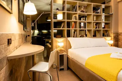 a bedroom with a bed and a desk and a chair at Andy Home in Rome