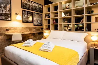 a bedroom with a bed with towels on a yellow blanket at Andy Home in Rome