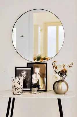 a mirror on top of a shelf with pictures at Geppy Vacation home near Saint Peter Basilica in Rome