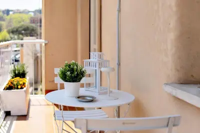 a white table and two chairs on a balcony at Geppy Vacation home near Saint Peter Basilica in Rome