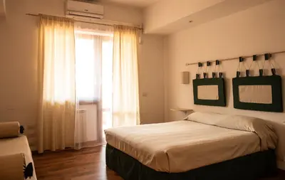 a bedroom with a bed and a large window at Domus Piscariae in Rome