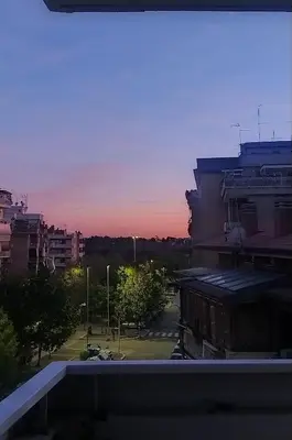 a view of a city at sunset from a building at Domus Piscariae in Rome