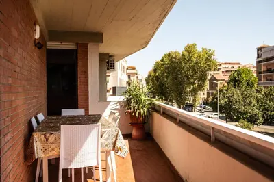a balcony with a table and chairs on a building at Domus Piscariae in Rome