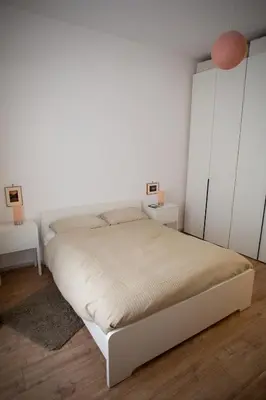 a white bedroom with a bed and white cabinets at Apartment Sora Marcella, Testaccio in Rome