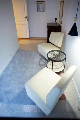 a living room with two chairs and a table at Apartment Sora Marcella, Testaccio in Rome