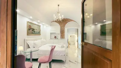 a bedroom with a bed and a table and chairs at Domus Jana 30 in Rome