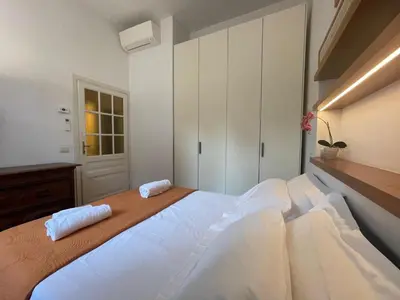 a bedroom with a large bed with two towels on it at Albani Retreat in Rome