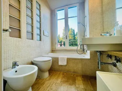 a bathroom with a toilet and a sink and a tub at Albani Retreat in Rome