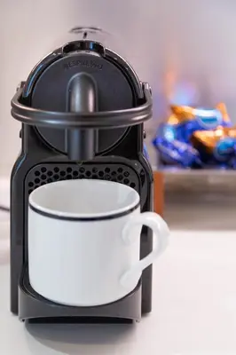 a black and white coffee maker with a white cup at Albani Retreat in Rome