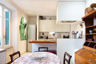 a kitchen with a table and a white refrigerator at Albani Retreat in Rome