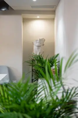 a white dog looking at its reflection in a mirror at Roma suite hotel in Rome