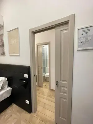 a room with a bathroom with a door and a toilet at Marcelina Holidays in Rome