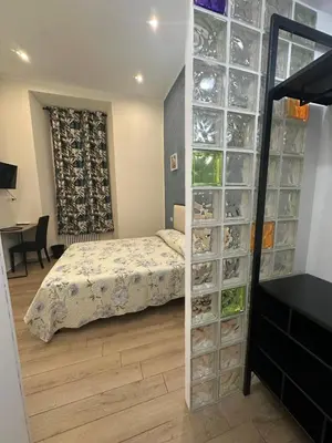 a bedroom with a bed and clear glass cases at Marcelina Holidays in Rome