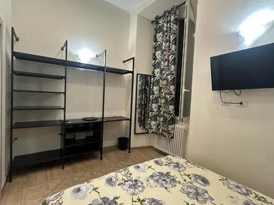 a bedroom with a bed and a flat screen tv at Marcelina Holidays in Rome