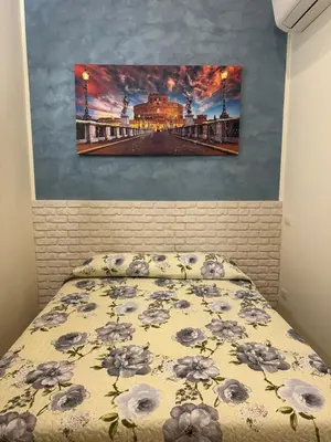 a bedroom with a bed and a painting on the wall at Marcelina Holidays in Rome