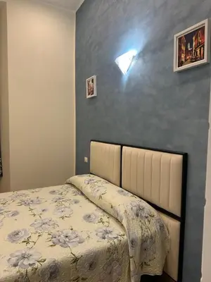 a bedroom with a bed and a blue wall at Marcelina Holidays in Rome
