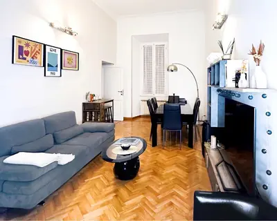 a living room with a blue couch and a table at Casa Bellezza a Cola di Rienzo in Centro in Rome