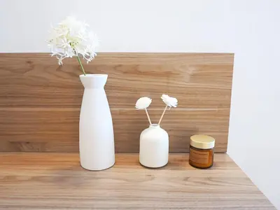 two white vases and a jar of honey on a shelf at Casa Bellezza a Cola di Rienzo in Centro in Rome