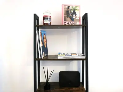 a black book shelf with a speaker on it at Casa Bellezza a Cola di Rienzo in Centro in Rome