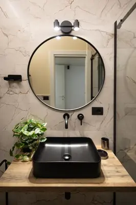 a bathroom with a black sink and a mirror at Yasmine Luxury Apartment in San Giovanni in Rome