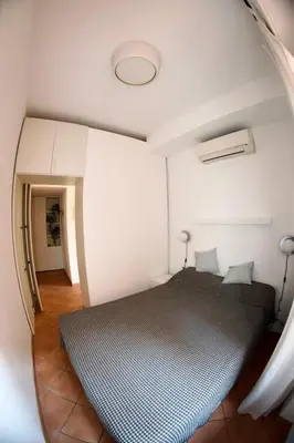 a small bedroom with a bed in a room at San Vito Cozy Apartment in Rome