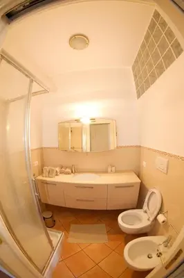 a bathroom with a tub and a toilet and a sink at San Vito Cozy Apartment in Rome