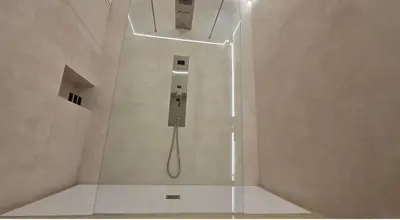 a shower with a glass enclosure in a bathroom at DUNE at Spanish Steps Luxury Apartment-Suite in Rome